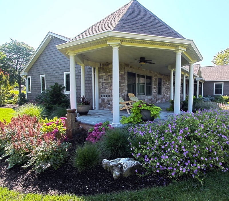 Gazebo house extension surrounded by maintained foliage