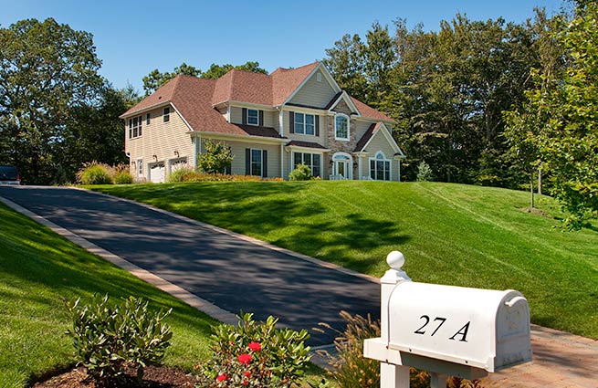 distant house with clean cut grass lawn